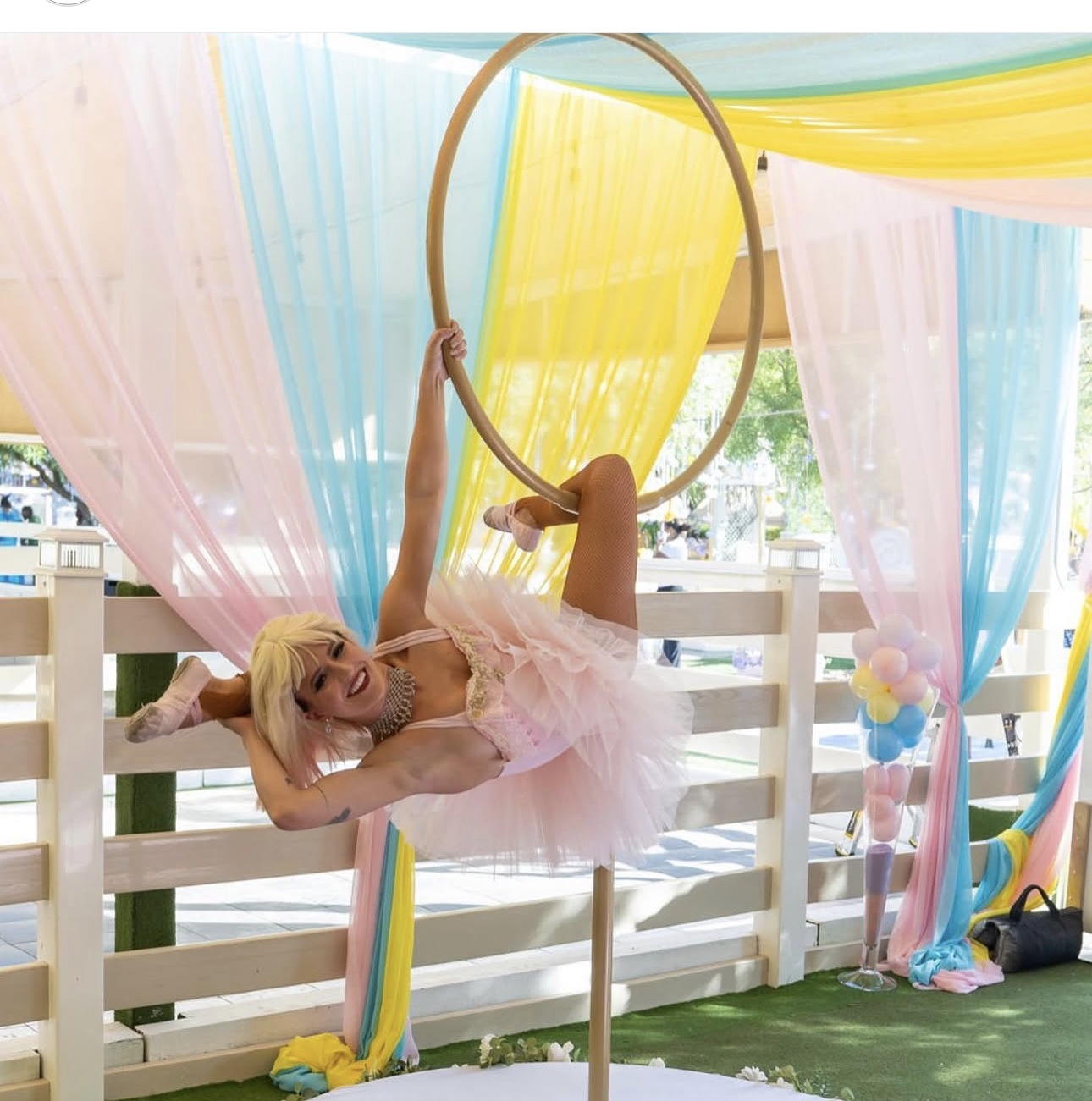 Aerial performer under rainbow drapery