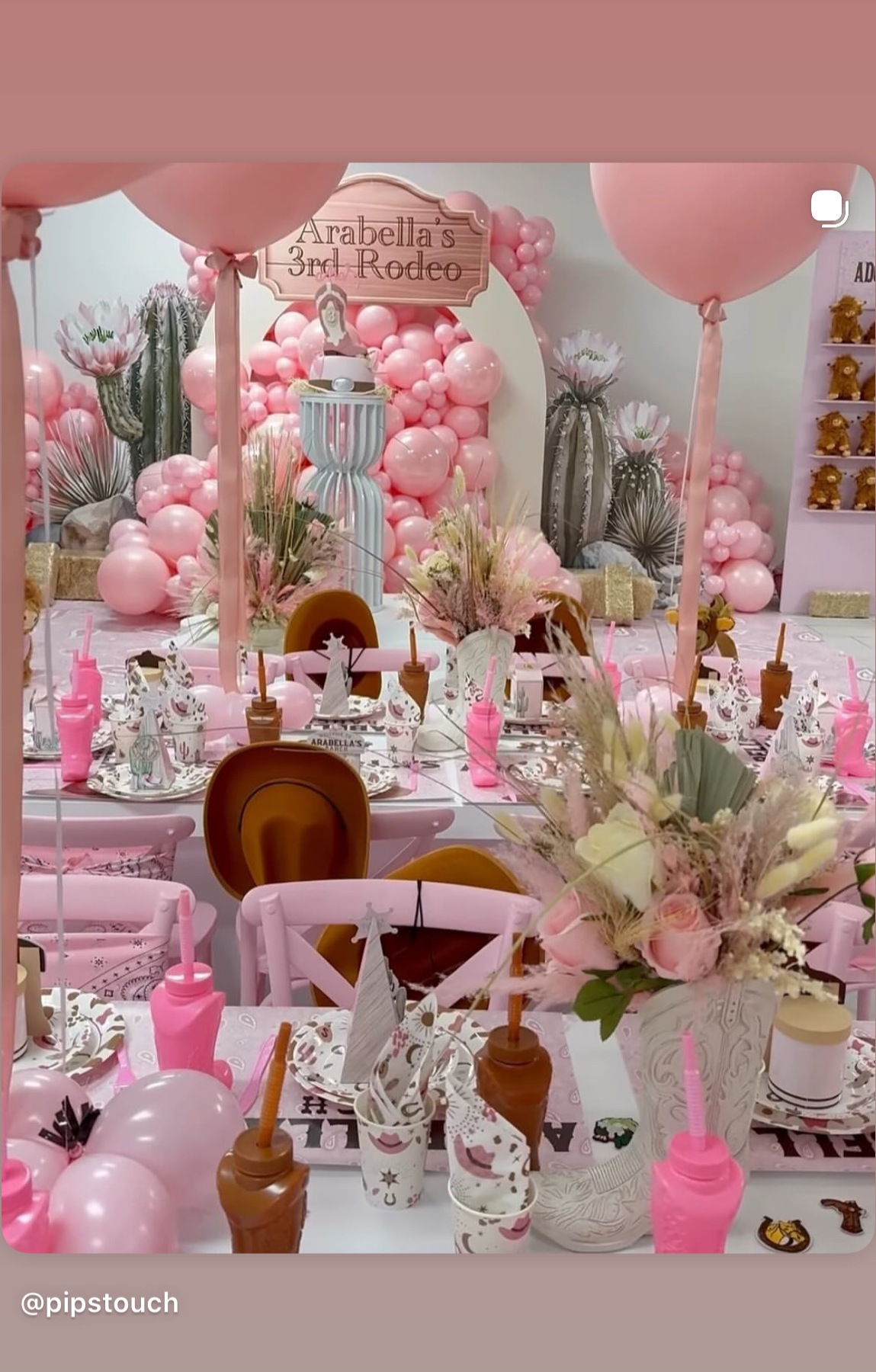 Pink rodeo themed table with balloon garlands and custom place settings